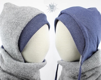 May include: Two hooded hats with a scarf. The hat on the left is grey with a blue trim. The hat on the right is blue with a grey trim. Both hats have a scarf that is the same colour as the hat.