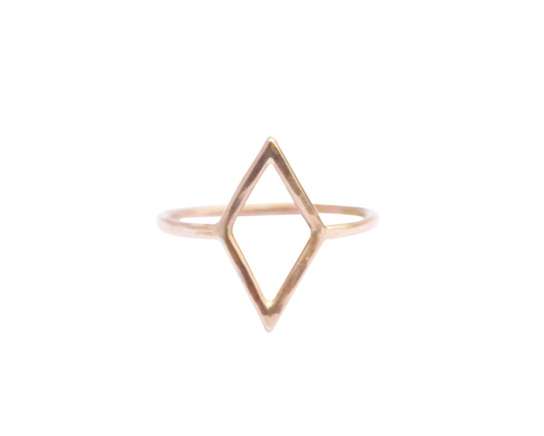 Very thin wire creating the outline of a diamond shape with thin wire as the ring band. Shown in gold tone or gold fill with a light hammered finish.