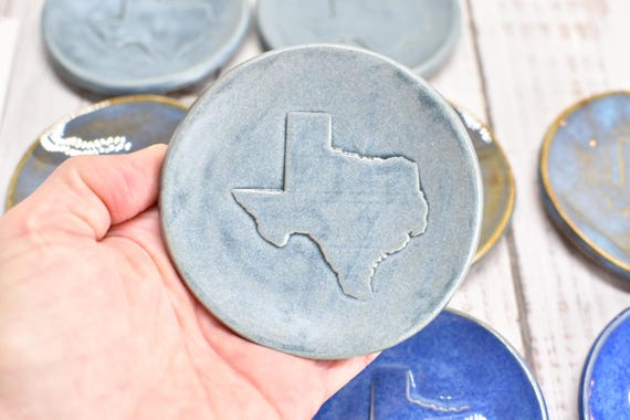 Hand-painted Texas-shaped stoneware spoon rest that doubles as a trinket dish — specific, functional, and actually made by a potter's hands.