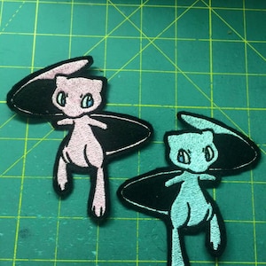 May include: Two embroidered iron-on patches of the Pokemon Mewtwo, one pink and one blue, each riding a black surfboard.