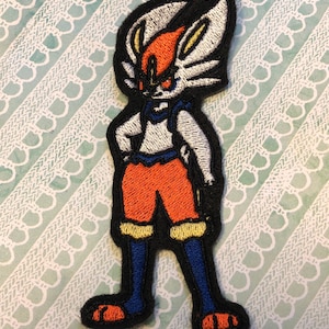 May include: Embroidered patch of a white and orange character with blue legs and orange feet. The character is standing with its arms crossed and has a white and blue collar.