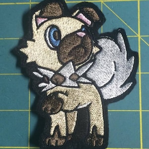 May include: Embroidered patch of a brown and white dog with a silver collar and a blue eye. The dog is standing on all fours and has a friendly expression.