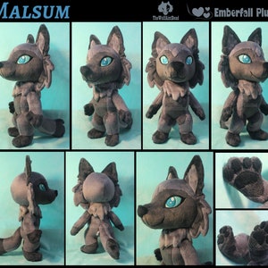 May include: A gray and black plush wolf toy with blue eyes. The toy is standing on a light blue background. The toy is about 6 inches tall. The toy is called "Malsum" and is an "Emberfall Plush".