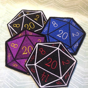 May include: Four embroidered patches shaped like twenty-sided dice. The dice are in black, purple, blue, and white with white, gold, and red numbers.