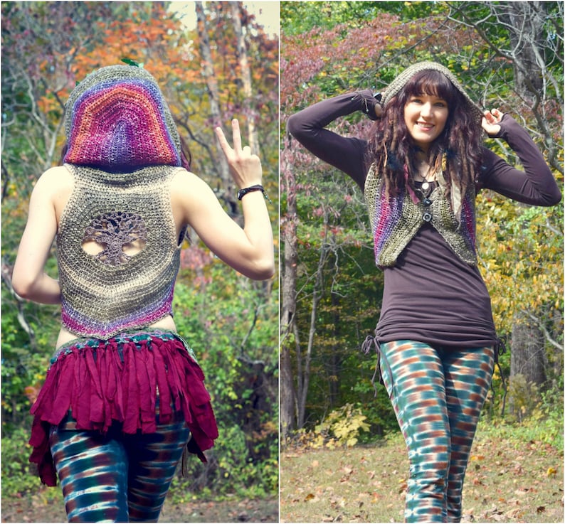 May include: A woman wearing a crocheted vest with a tree design on the back. The vest has a hood and is made with a rainbow of colors. She is also wearing a long-sleeved shirt, leggings, and a crocheted hat.