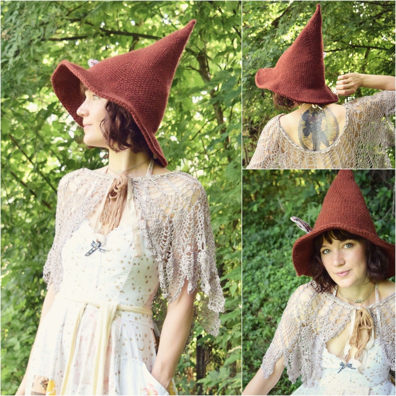 May include: A woman wearing a brown pointed witch hat with a wide brim and a crocheted shawl. She is standing in a forest setting.