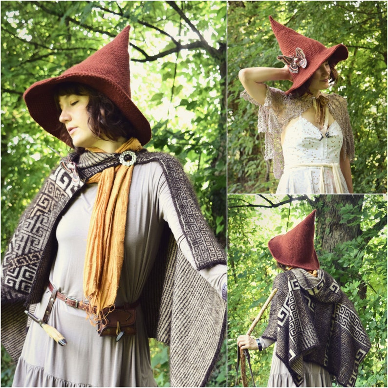 May include: A woman wearing a brown knitted hat with a pointed top and a brown and white patterned cape. She is standing in a forest setting.
