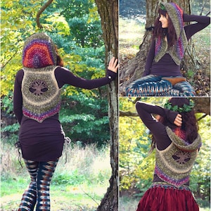 May include: A crocheted vest with a tree of life design and a rainbow-colored hood. The vest is worn over a brown shirt and paired with colorful leggings.