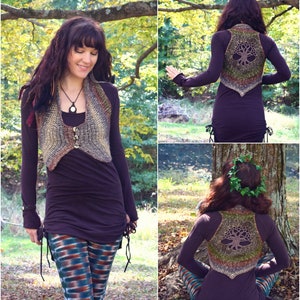 May include: A woman wearing a brown crocheted vest with a tree design on the back. The vest has a pointed bottom and is worn over a long-sleeved purple shirt and patterned leggings.