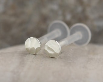 May include: Two silver hammered disc earrings with clear acrylic posts.