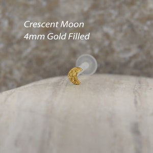 Minimalist tragus and helix earring in classic gold, made from bioflex. Its sleek design crescent moon offers a stylish option for layering with other ear jewelry.