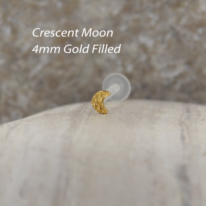 Minimalist tragus and helix earring in classic gold, made from bioflex. Its sleek design crescent moon offers a stylish option for layering with other ear jewelry.