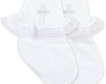 May include: White baby socks with a cross embroidered on each sock. The socks have a lace trim around the top.