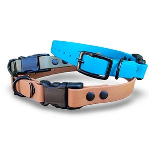 May include: Two pet collars, one in a bright turquoise blue and the other in a tan brown. Both collars feature black hardware, including a buckle, a D-ring for leash attachment, and a sliding keeper. The tan collar has a side-release plastic buckle.