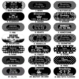 May include: Twenty-one black and white oval-shaped pet ID tags with different designs. Each tag has a name and phone number printed in white. The designs include boho rainbows, bows, butterflies, claddagh, crown, damask, fire, hearts, honeycomb, mountains, mandalas, geometric, paws, forest, stars, suns, toile, pines, celtic, bigfoot on dino, and bee with flowers.