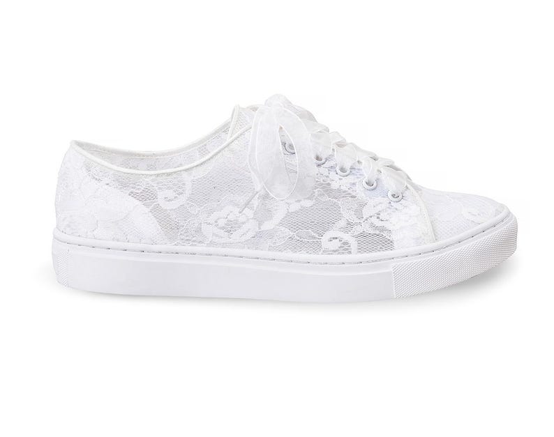 May include: White lace sneakers with a white ribbon tied around the ankle.