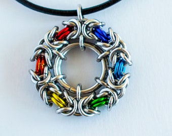 May include: A rainbow colored metal chainmail pendant necklace with a black leather cord.