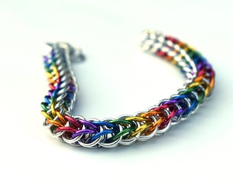 May include: A rainbow colored chainmail bracelet made of silver and colored metal rings.