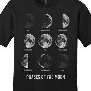 May include: Black t-shirt with a graphic of the phases of the moon. The graphic shows the moon in different stages of its cycle, from new moon to full moon. The text "PHASES OF THE MOON" is printed below the graphic.