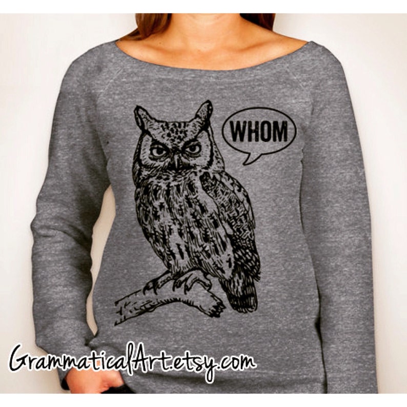 May include: Gray sweatshirt with a black and white illustration of an owl perched on a branch. The owl has a speech bubble above it that says "WHOM".