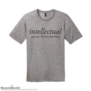 May include: A heather grey t-shirt with the text "intellectual you say it like it's a bad thing" printed in black.
