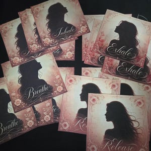 May include: A collection of square cards featuring a black silhouette of a person in profile against a soft pink background with floral accents. Each card displays a different word in elegant script, including Inhale, Exhale, Breathe, and Release.
