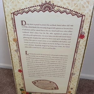 May include: A limited edition Moana doll from Disney Store. The doll is wearing a brown and white woven skirt with tassels, a shell necklace, and a red flower in her hair. The box features a brown and white background with text in English and French.