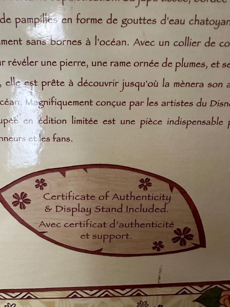 May include: A brown leaf-shaped certificate of authenticity with white text that reads "Certificate of Authenticity & Display Stand Included. Avec certificat d'authenticit&eacute; et support."