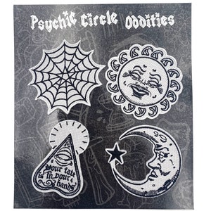 May include: Set of four black and white embroidered iron-on patches with a spooky theme. The patches feature a spiderweb, a sun with a face, a crescent moon with a face, and a triangle with an eye and the text "Your fate is in your hands".
