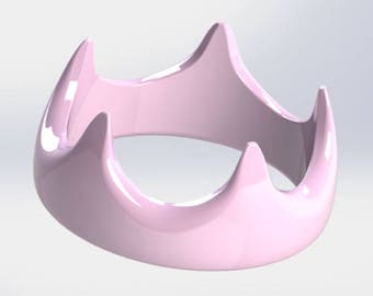 Könnte beinhalten: Ein glänzendes, hellrosa, abstraktes ringförmiges Objekt mit vier nach oben gebogenen Spitzen. Das Design ist glatt und symmetrisch, mit einer reflektierenden Oberfläche. Das Objekt scheint ein dekoratives oder künstlerisches Stück zu sein.