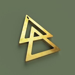 May include: A gold-colored metal triangle with a smaller triangle inside. The triangles are overlapping and have a 3D effect.