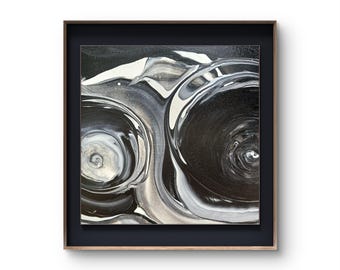 May include: Abstract art piece with a swirling design in shades of black, white, and gray. The artwork is framed in a dark blue mat and a wooden frame. The fluid paint effect creates a dynamic and modern aesthetic.