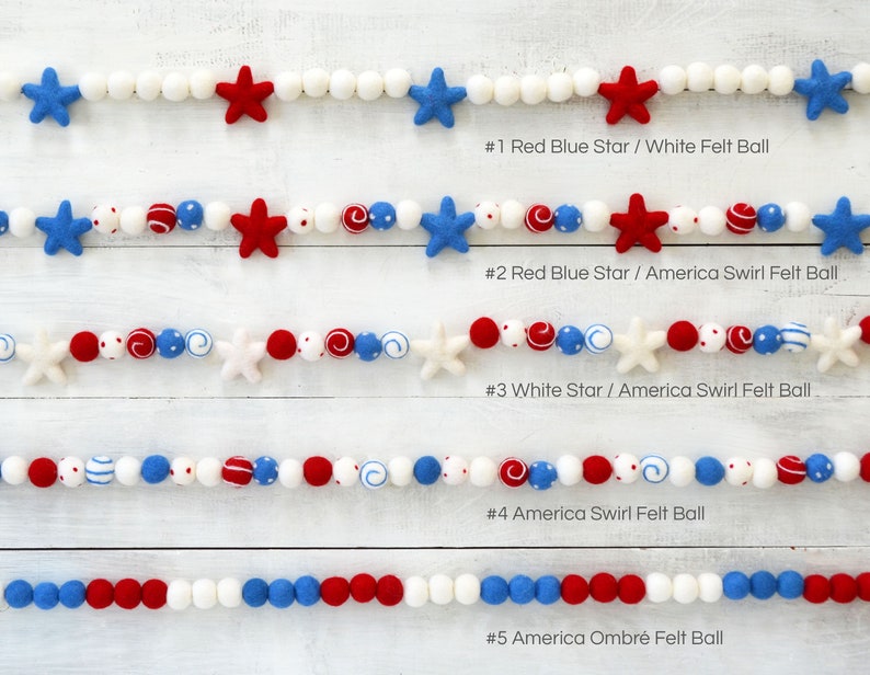 May include: Five different styles of felt ball garlands, each with a different pattern. The garlands are made with red, white, and blue felt balls and feature stars and swirls. #1 Red Blue Star / White Felt Ball, #2 Red Blue Star / America Swirl Felt Ball, #3 White Star / America Swirl Felt Ball, #4 America Swirl Felt Ball, #5 America Ombr&eacute; Felt Ball.