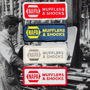 May include: Four vintage embroidered patches with a red, blue, white, and grey background. Each patch features the NAPA logo and the text "MUFFLERS & SHOCKS".