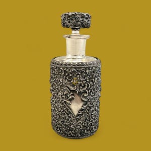 Antique ornate metal filigree perfume bottle with stopper