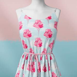 May include: A light blue sleeveless dress with a pink heart balloon pattern. The dress has a pink ribbon tied at the waist.
