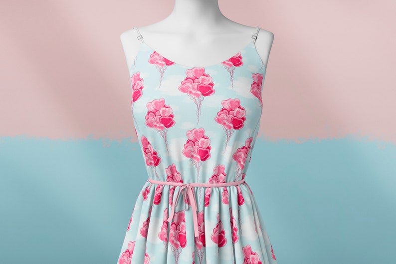 May include: A light blue sleeveless dress with a pink heart balloon pattern. The dress has a pink ribbon tied at the waist.