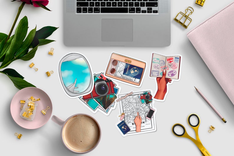 May include: A set of travel-themed stickers featuring a passport with stamps, a camera, a map, an airplane window, and a passport holder. The stickers are on a white background.
