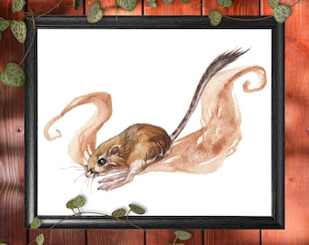 May include: A framed watercolor print featuring a small, brown and tan rodent with a long tail. The rodent is depicted on a light brown, abstract shape. The print is in a black frame, set against a wooden background.