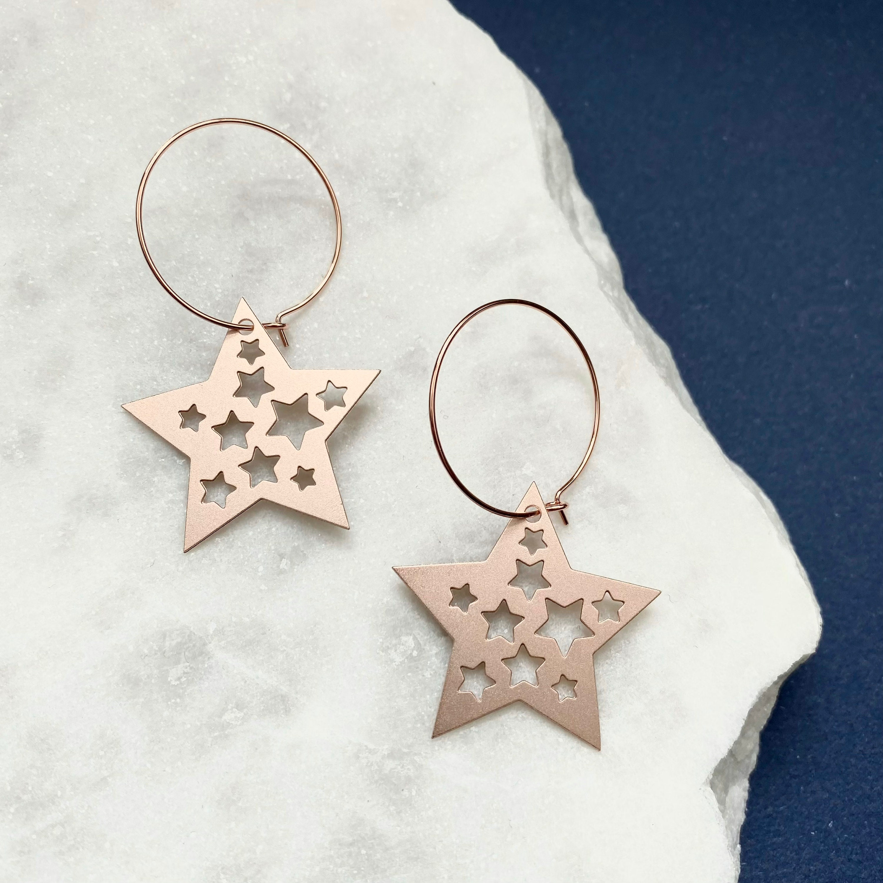 Rose gold star hoop best sale earrings