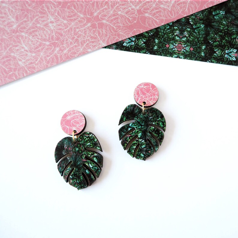 Pink and green statement monstera drop earrings. Pink wooden circle stud with green cheese plant leaf shape