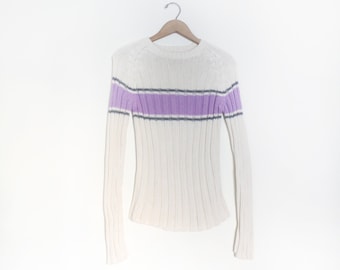 May include: A white ribbed knit sweater with a purple and gray striped band across the chest.
