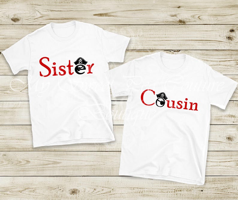 Two white t-shirts with red text that says "Sister" and "Cousin" printed on them, laid out on a wooden surface.