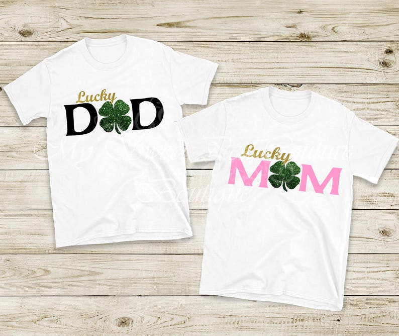 two white t-shirts with the text "Lucky Dad" and "Lucky Mom" printed on them, along with a green clover symbol.