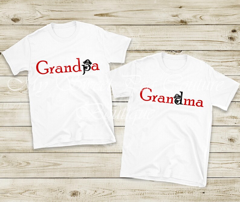 Two white t-shirts with the text "Grandpa" and "Grandma" printed on them, placed on a wooden surface.