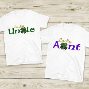 Two white t-shirts with the text "Lucky Uncle" and "Lucky Aunt" printed on them, along with a four-leaf clover symbol.