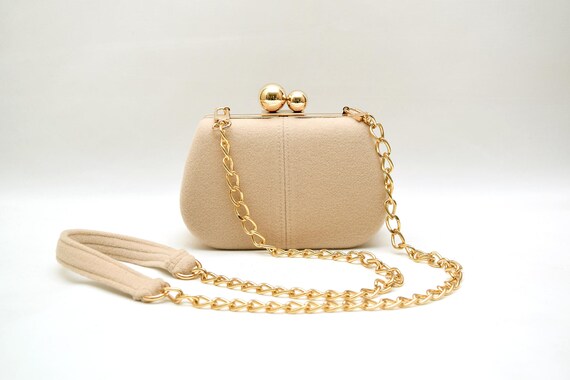 beige clutch bag with chain