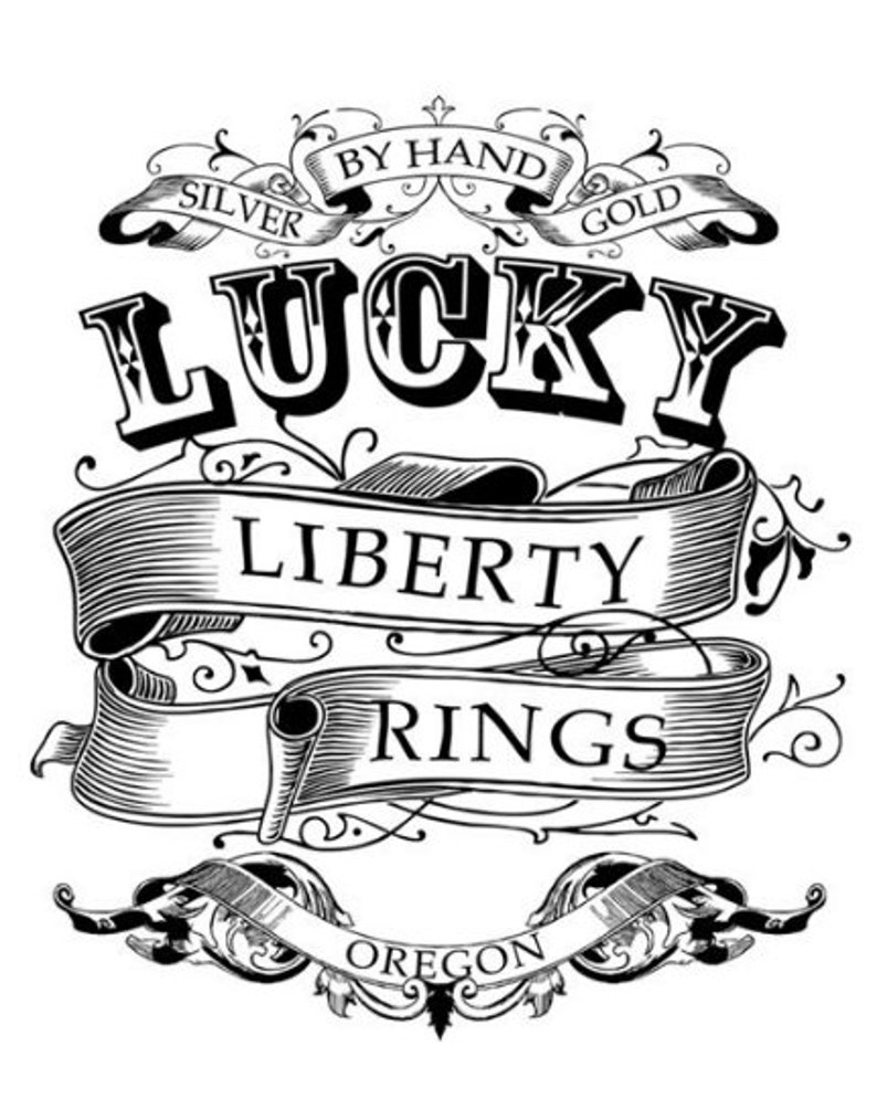 May include: Black and white illustration of a logo for Lucky Liberty Rings. The logo features a stylized banner with the words "Lucky Liberty Rings" and the text "By Hand Silver Gold" and "Oregon" in a decorative font.