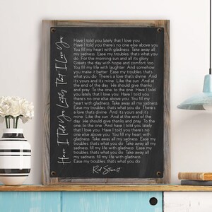 May include: Black and white print of a song lyric on a wooden background. The lyrics are for the song "Have I Told You Lately That I Love You" by Rod Stewart.