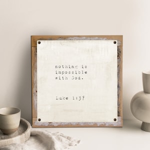 May include: A white wooden sign with the text "nothing is impossible with God. Luke 1:37" printed in black.